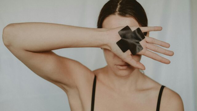 anonymous woman in lingerie demonstrating tape cross