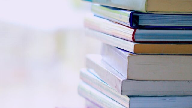 selective focus photo of pile of assorted title books