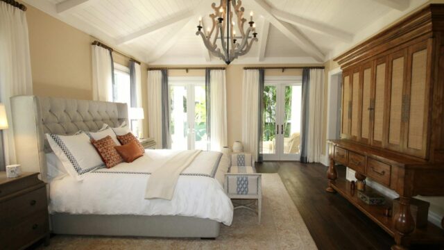 upholstered bed near cabinet