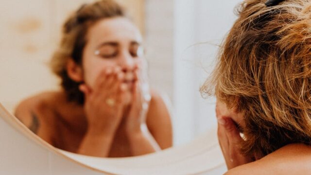 woman washing her face
