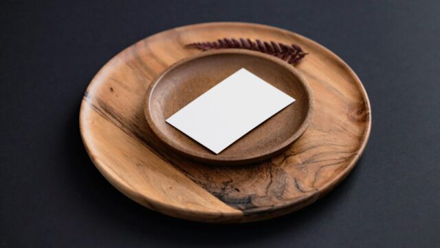 white card on brown wooden round plate