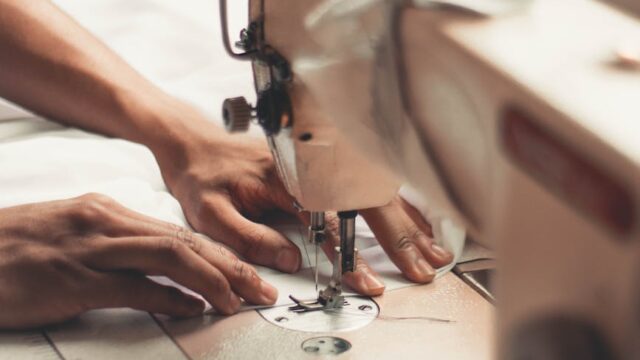 person holding sewing machine