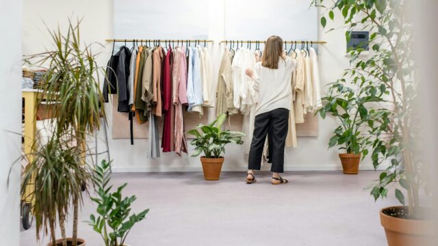woman fixing clothes on the rack