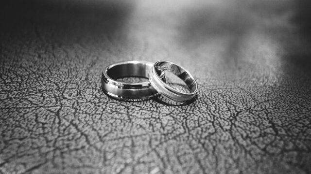 close up of wedding rings on floor